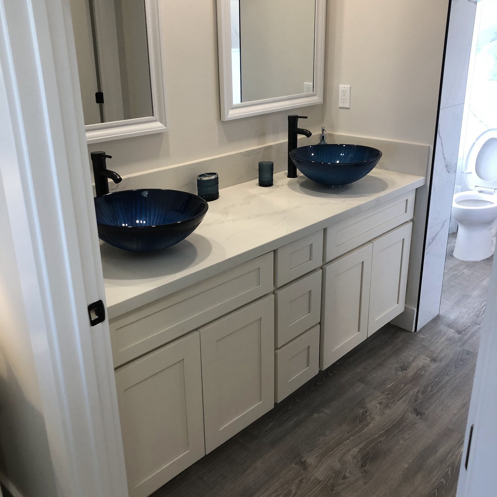 A finished bathroom vanity with supply lines connected